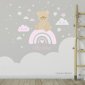 Teddy bear on the rainbow surrounded by stars and clouds. Pink color. Photo